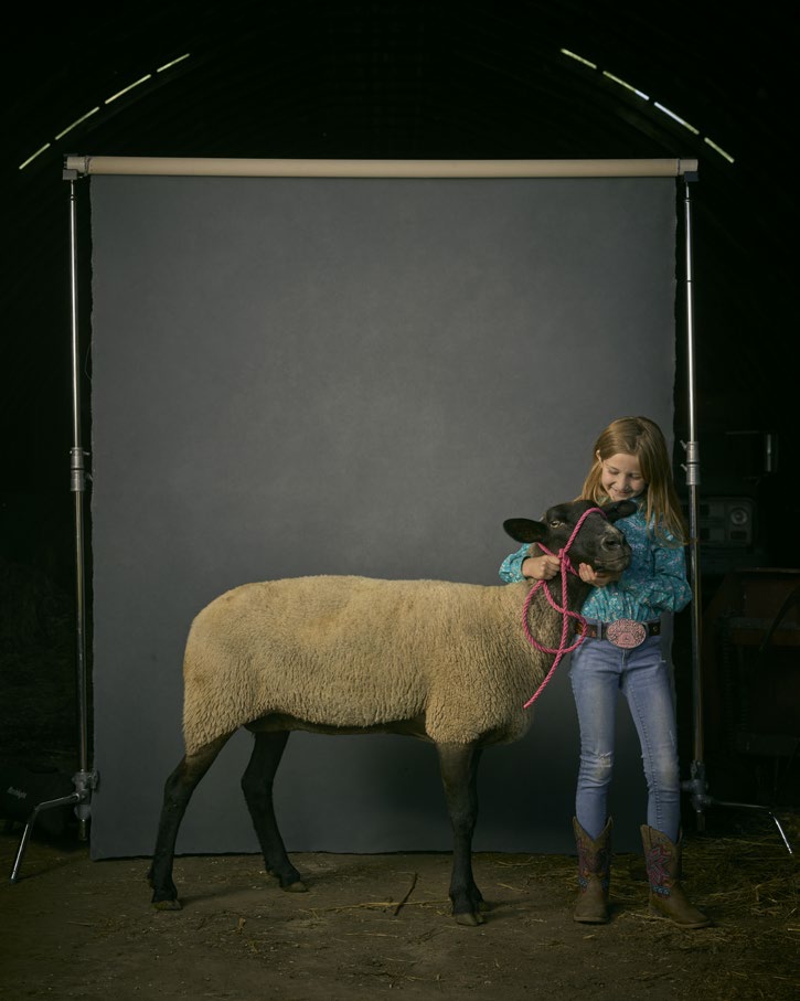 R. J. Kern Child poses with sheep.