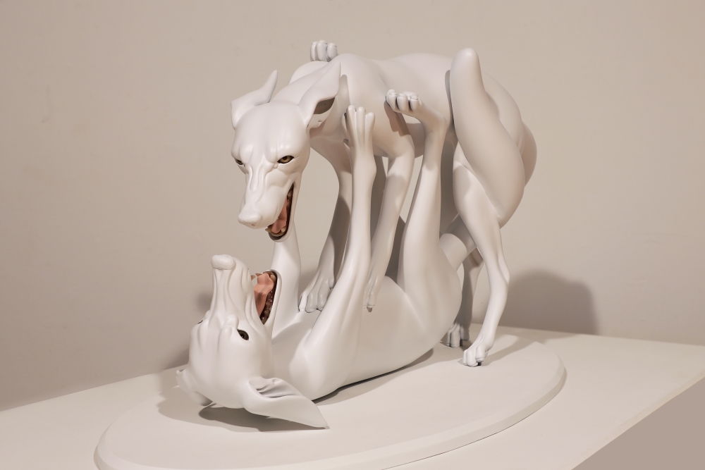 Jessica Teckemeyer Two polyurethane 3-dimensional dog figures fight, mouths open, one on its back, the other on top.